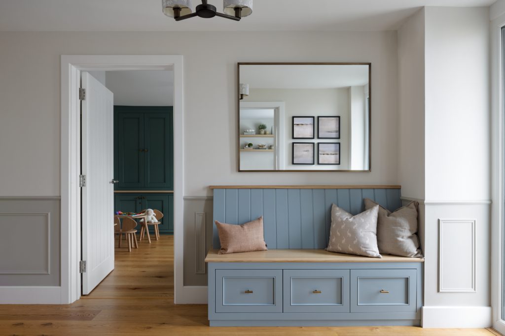 Bespoke joinery bench to wall with large mirror above